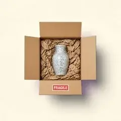 Fragile vase in bubble wrap with even cushioning on all sides and a Fragile sticker