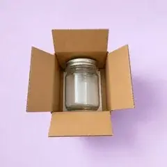 Jar against bare cardboard with no cushioning