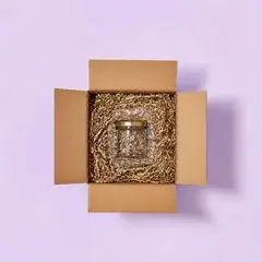 Box filled with shredded paper around a jar